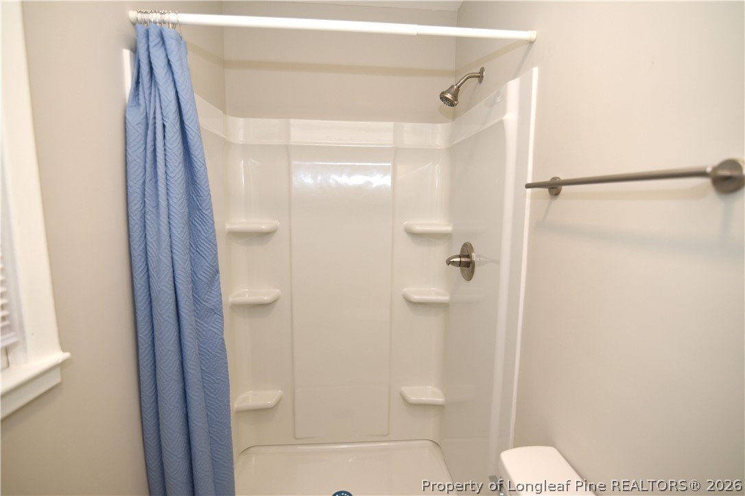 1673 Norment Road Lumberton, NC 28360 - Photo 20 of 32 a bathroom with a shower and toilet