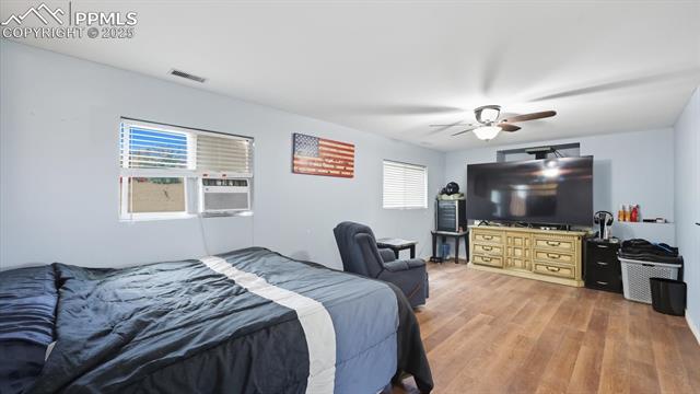 9715 Bar B Road Fountain, CO 80817 - Photo 22 of 34 The Lower Level Family Room features LVP floors, a lighted ceiling fan, and window a/c unit.