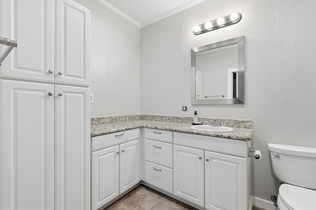 14277 Preston Road, Unit 615 Dallas, TX 75254 - Photo 16 of 20 a bathroom with a granite countertop toilet sink and mirror