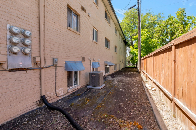434 South 700 West, Unit 2 Provo, UT 84601 - Photo 15 of 15 Brick exterior featuring multiple utility meters and window awnings