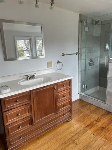a bathroom with a sink a toilet and shower