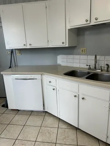 a kitchen with white cabinets