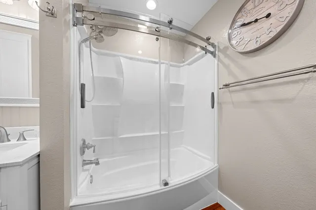 a bathroom with a bathtub and a shower