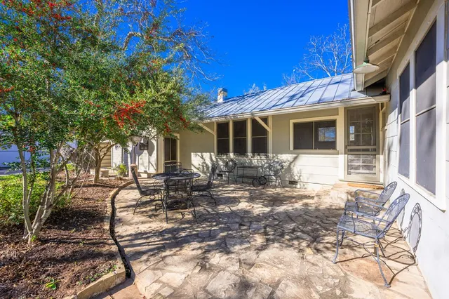 a view of a chair and tables in the patio