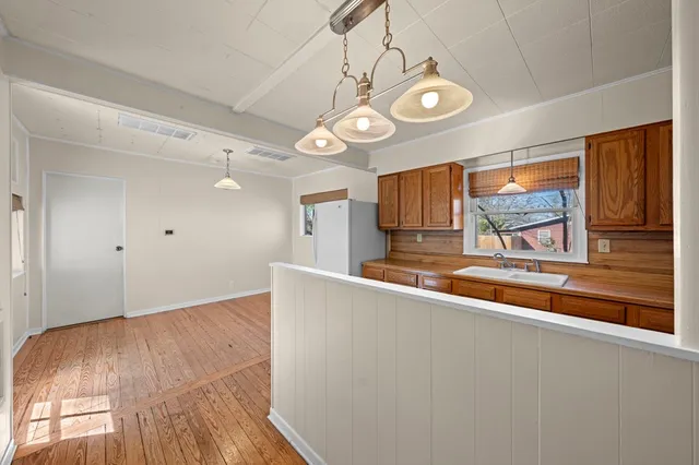 a view of a room with wooden floor and window