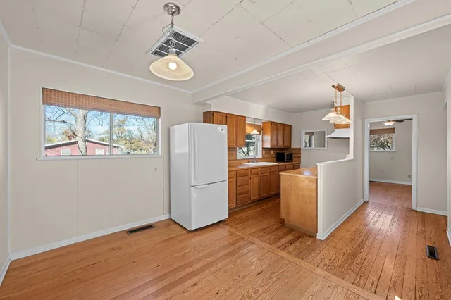 a view of kitchen and dining room with wooden floor