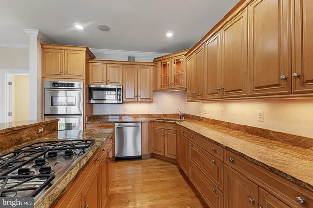 a view of a kitchen with wooden floor and cabinets