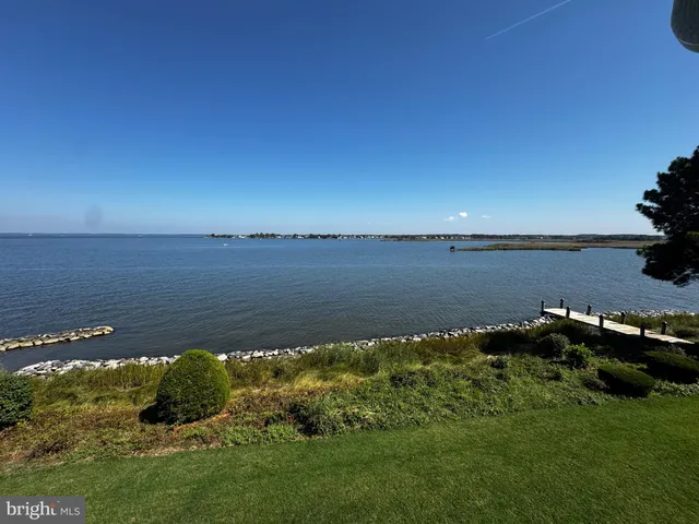 a view of a cafe with a table and chairs under an umbrella