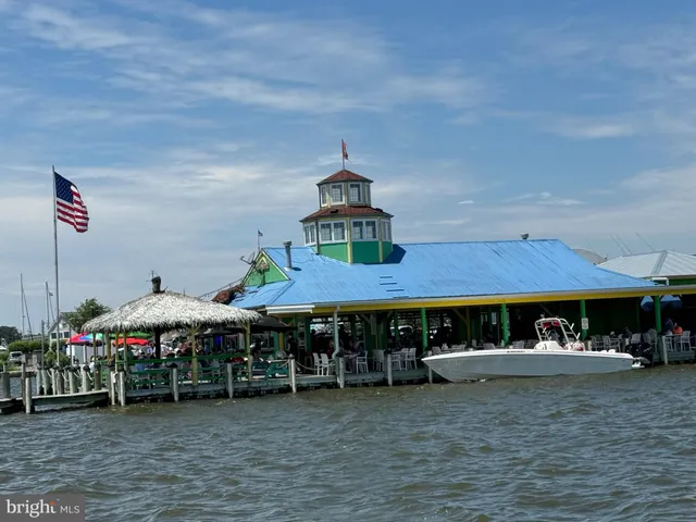 an aerial view of multiple houses with a yard