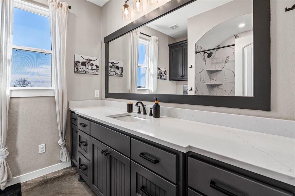 310 Runyan Rnch Road Tolar, TX 76476 - Photo 30 of 35 Bathroom featuring a marble finish shower and vanity