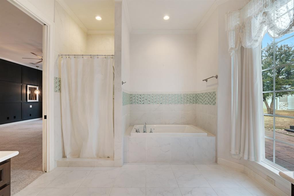 4705 Boulder Lane Paris, TX 75462 - Photo 22 of 33 a bathroom with a bathtub and a shower