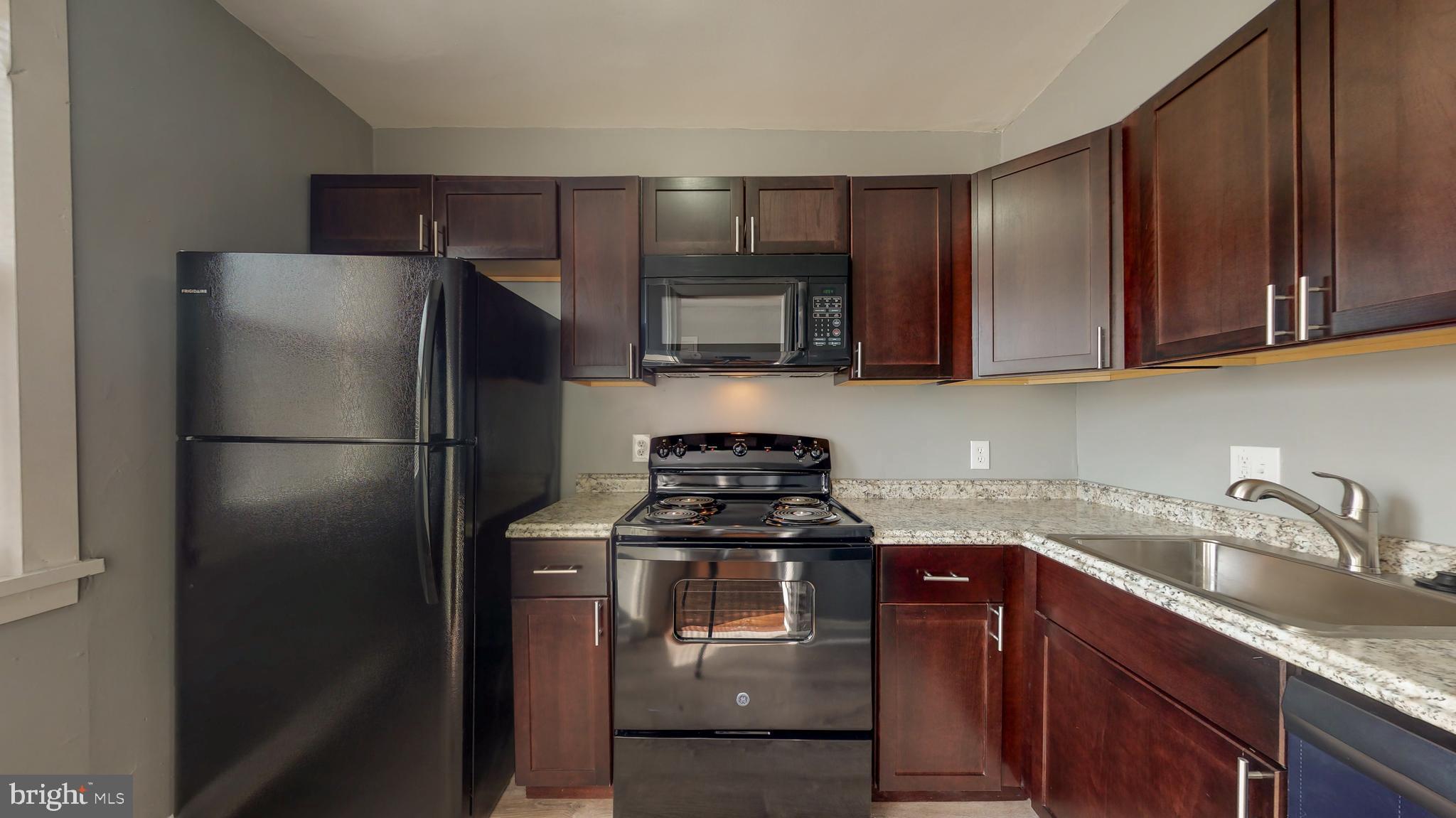 1102 Gleneagle Road Baltimore, MD 21239 - Photo 1 of 19 a kitchen with a sink stove and refrigerator