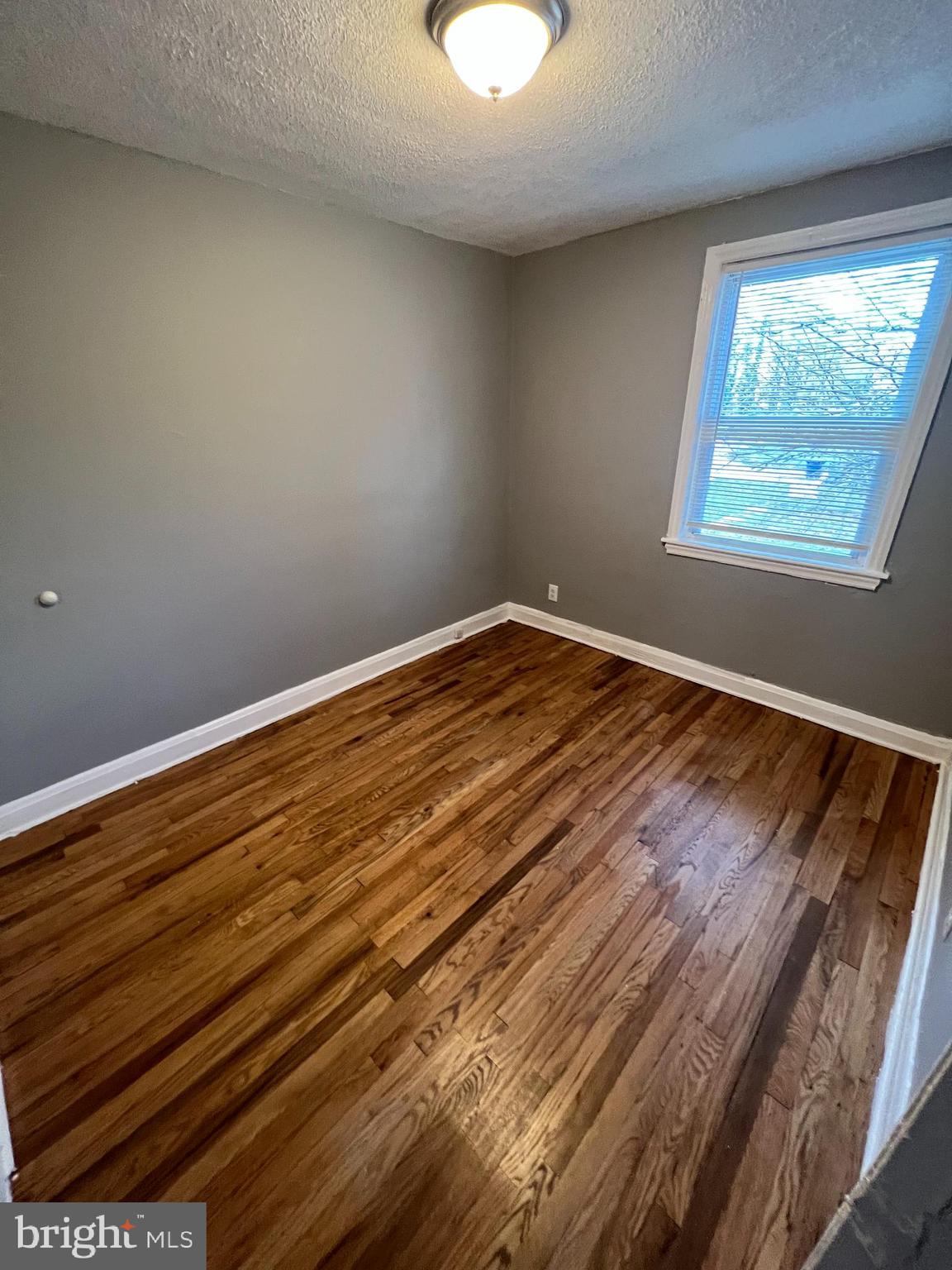 1102 Gleneagle Road Baltimore, MD 21239 - Photo 12 of 19 a view of wooden floor and chandelier in a room