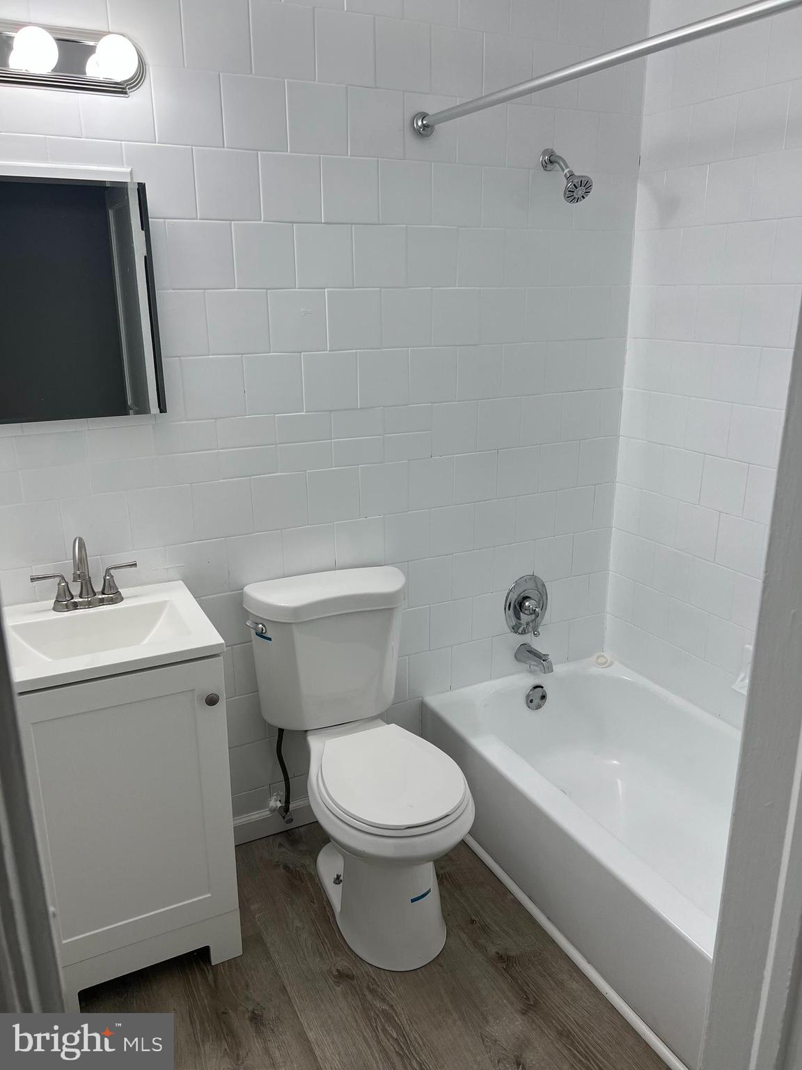1102 Gleneagle Road Baltimore, MD 21239 - Photo 13 of 19 a white toilet sitting next to a bathroom sink