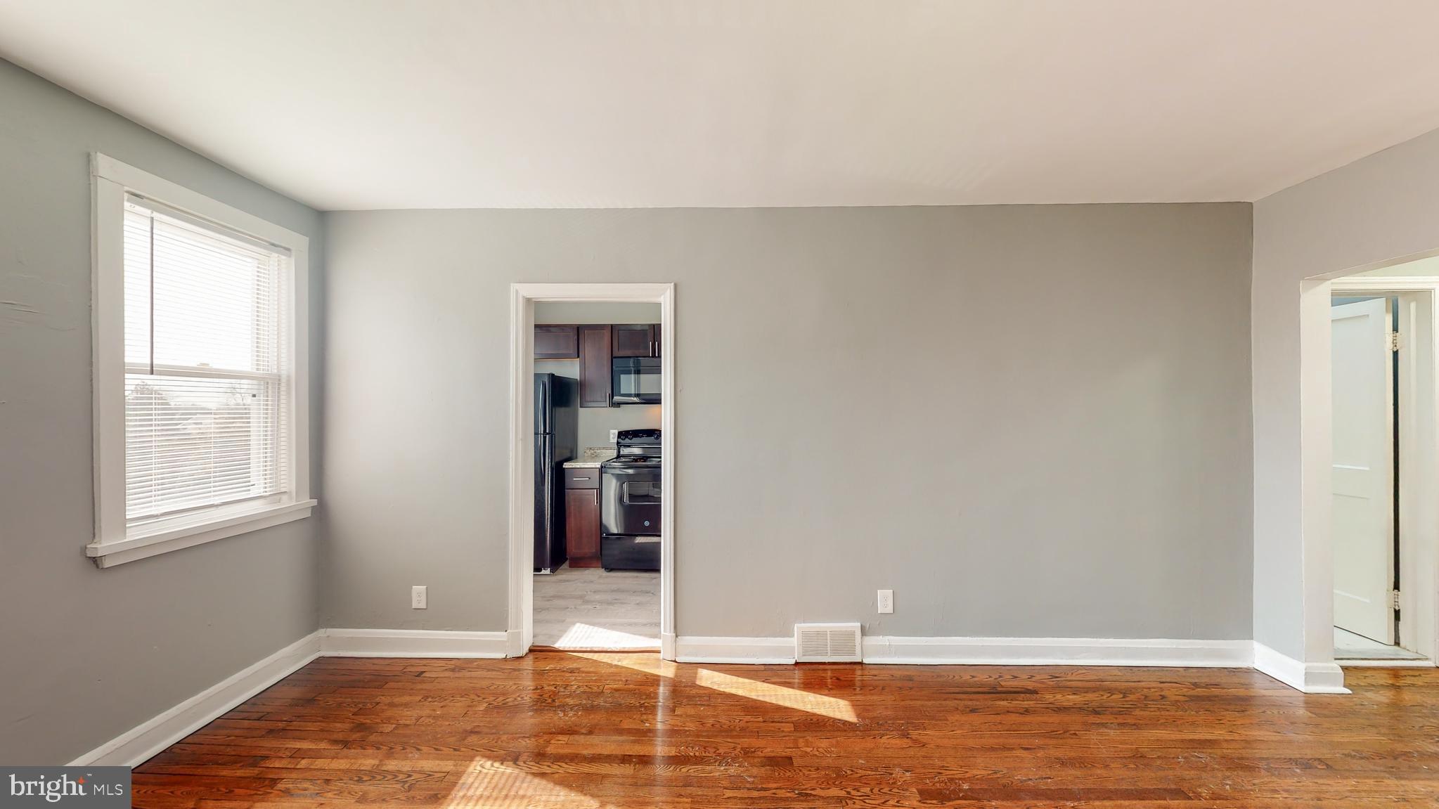 1102 Gleneagle Road Baltimore, MD 21239 - Photo 4 of 19 a view of an empty room with window and closet area