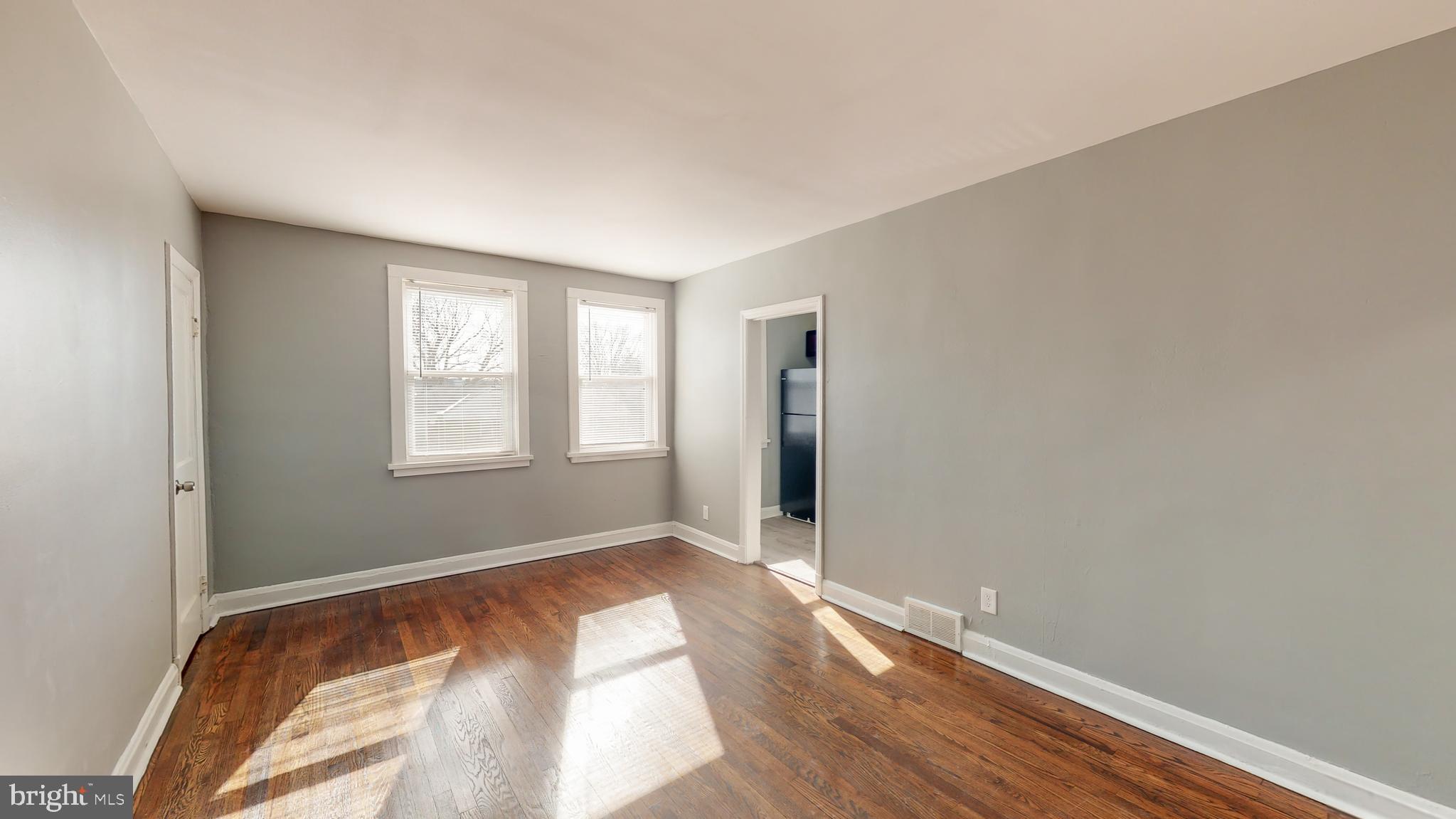 1102 Gleneagle Road Baltimore, MD 21239 - Photo 5 of 19 a view of room with window and wooden floor