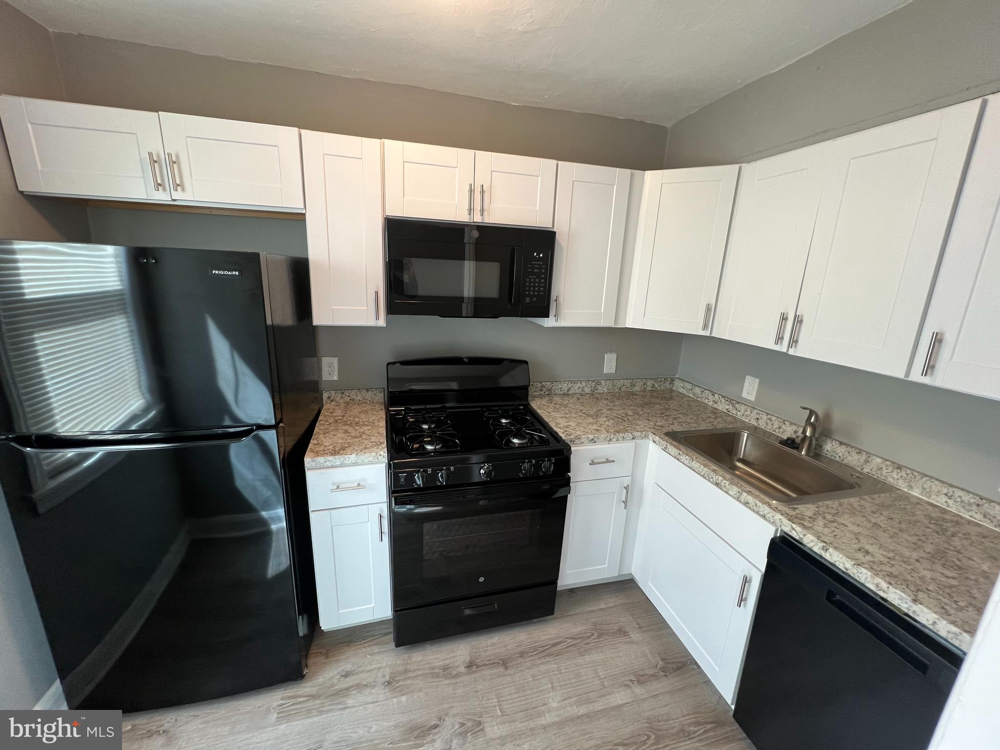 1102 Gleneagle Road Baltimore, MD 21239 - Photo 8 of 19 a kitchen with stainless steel appliances granite countertop a stove a refrigerator a sink and dishwasher