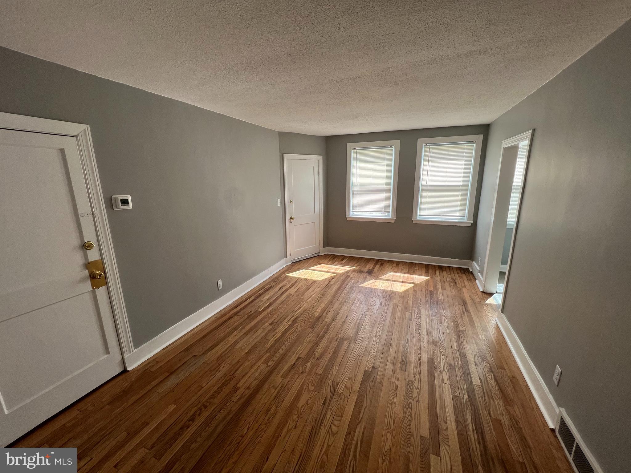 1102 Gleneagle Road Baltimore, MD 21239 - Photo 9 of 19 wooden floor in an empty room with a window