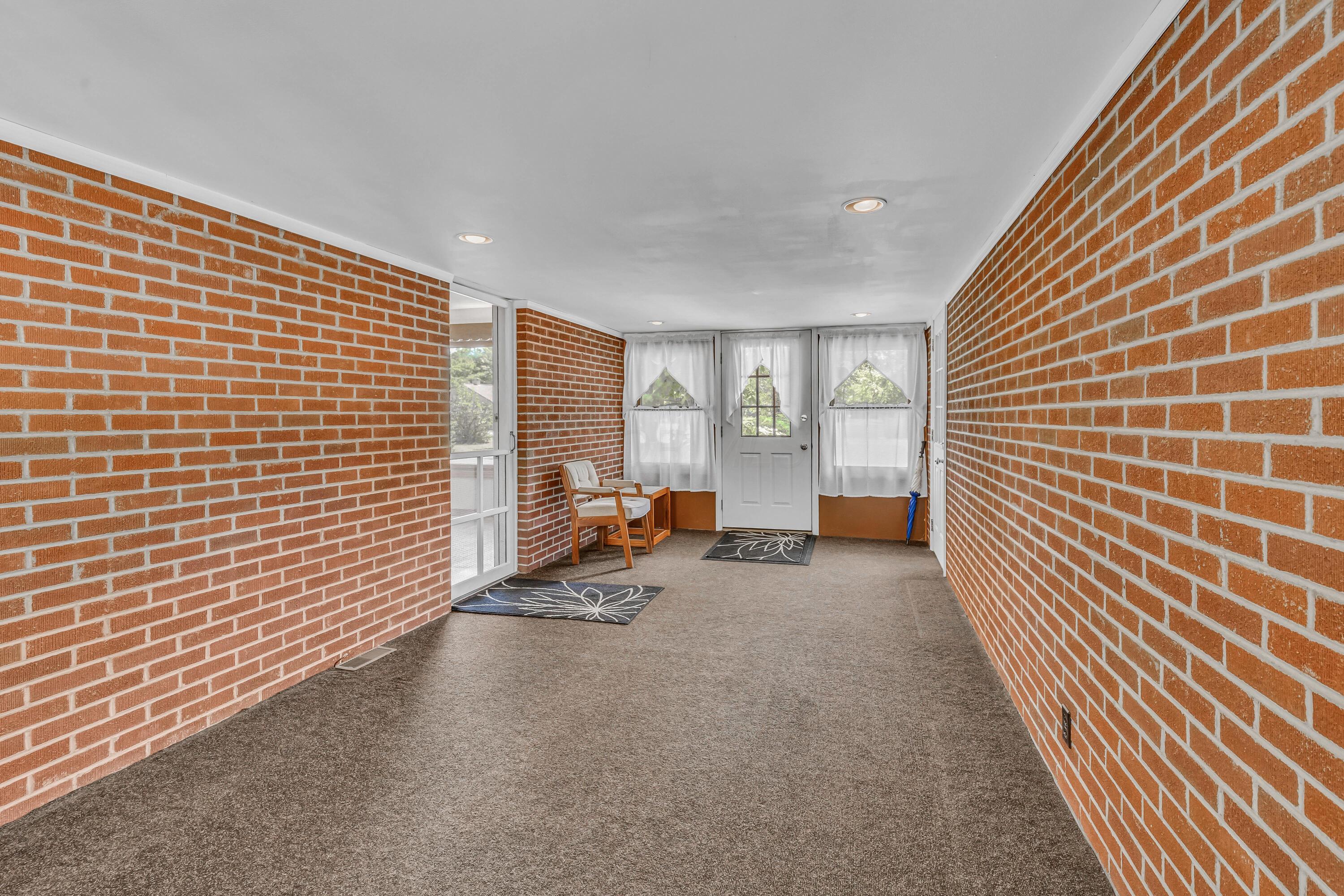 1213 East Cooke Road Columbus, OH 43224 - Photo 9 of 57 • Carpet • Brick walls • Can lighting • Front & rear door • Access to Garage
