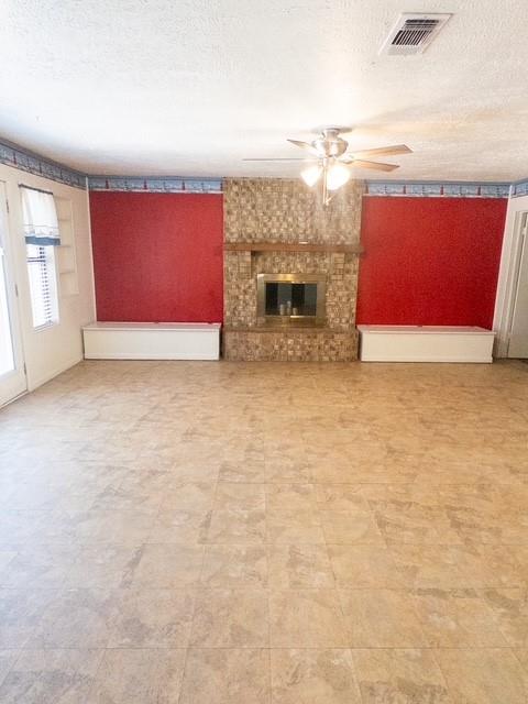 613 Laurel Road Athens, TX 75751 - Photo 3 of 13 Stone-clad fireplace with a metal insert, flanked by built-in bench seating and shelving