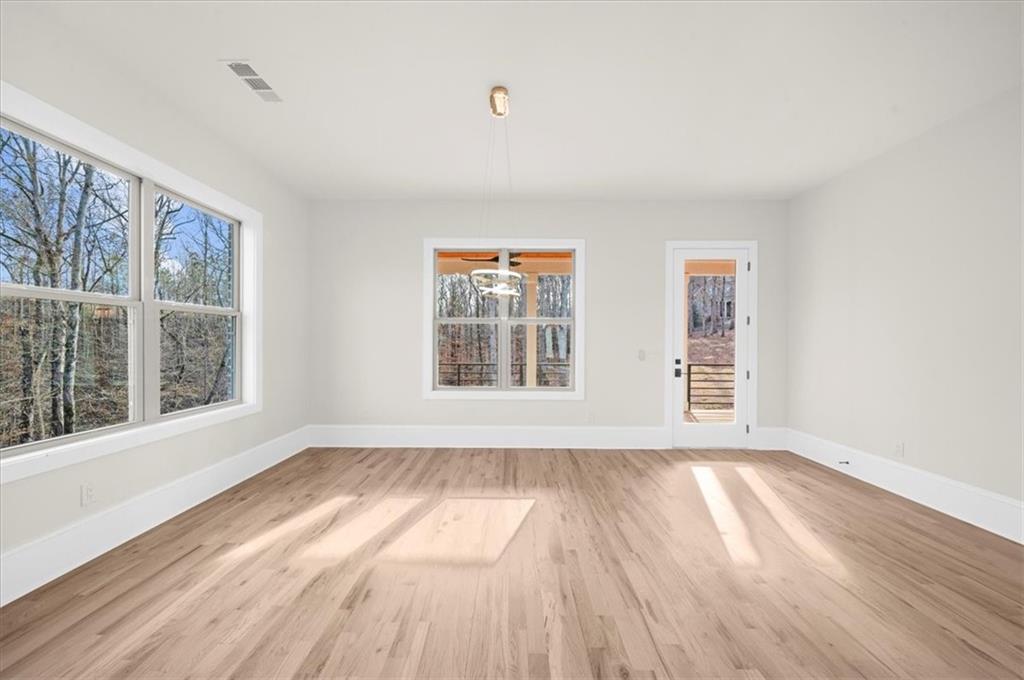 4543 Fawn Path Gainesville, GA 30506 - Photo 27 of 96 a view of an empty room with wooden floor and a window
