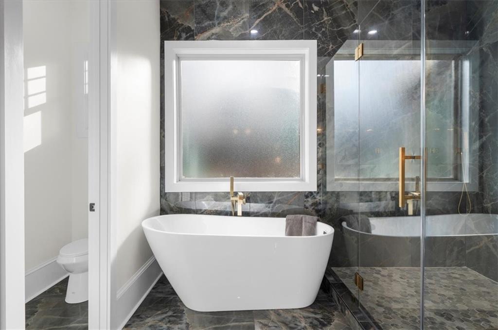 4543 Fawn Path Gainesville, GA 30506 - Photo 54 of 96 a white bath tub sitting next to a bathroom sink