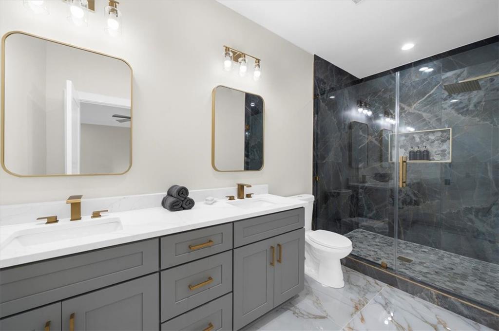 4543 Fawn Path Gainesville, GA 30506 - Photo 77 of 96 a bathroom with a double vanity sink mirror double shower and a toilet