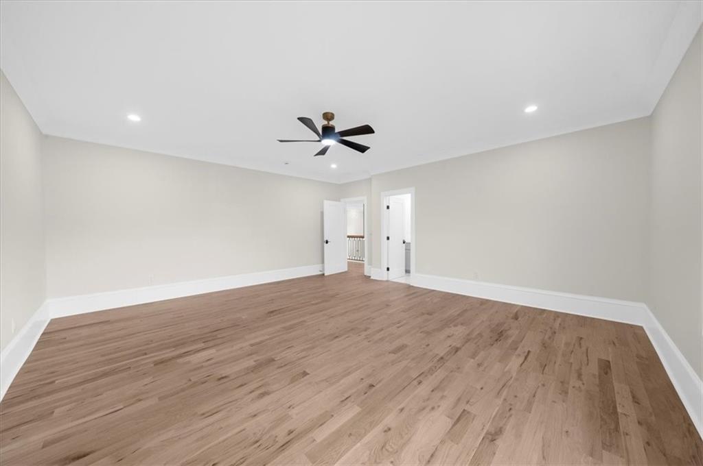 4543 Fawn Path Gainesville, GA 30506 - Photo 78 of 96 an empty room with wooden floor and ceiling fan