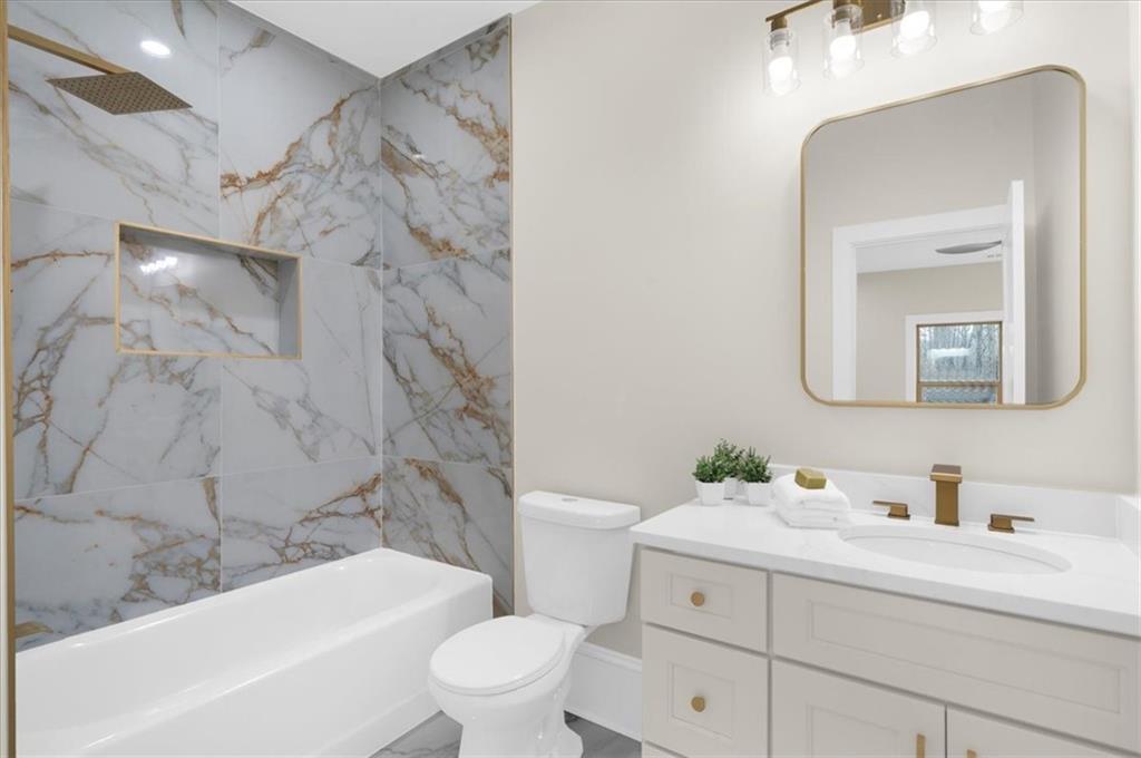 4543 Fawn Path Gainesville, GA 30506 - Photo 82 of 96 a bathroom with a sink a toilet and shower