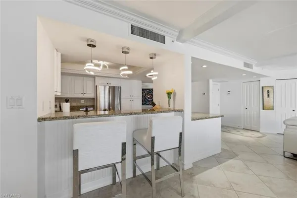 a kitchen with a table and chairs in it