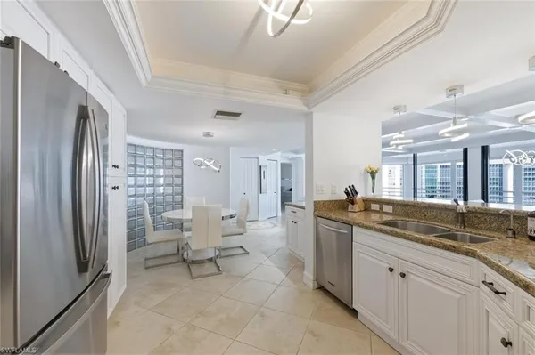 a spacious bathroom with a granite countertop sink and a large mirror