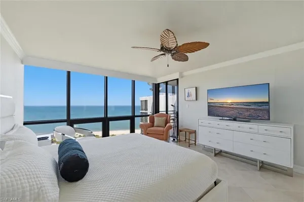 a bedroom with a bed and with flat screen tv