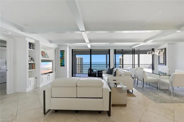 a living room with furniture and large window
