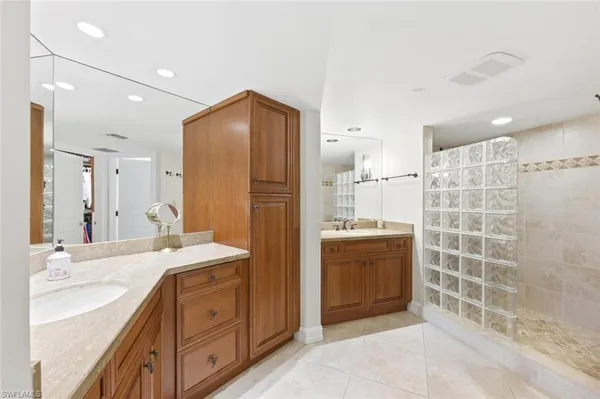 a bathroom with a double sink shower and a mirror