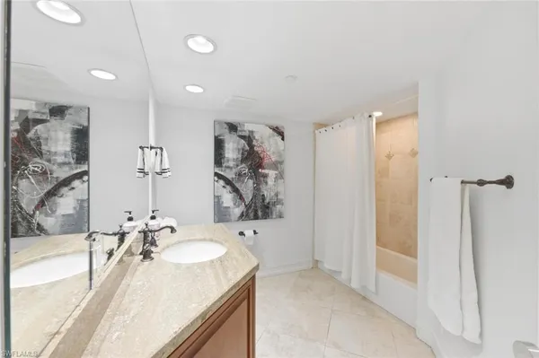 a bathroom with a bathtub sink and mirror