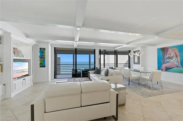 a living room with furniture large window and flat screen tv