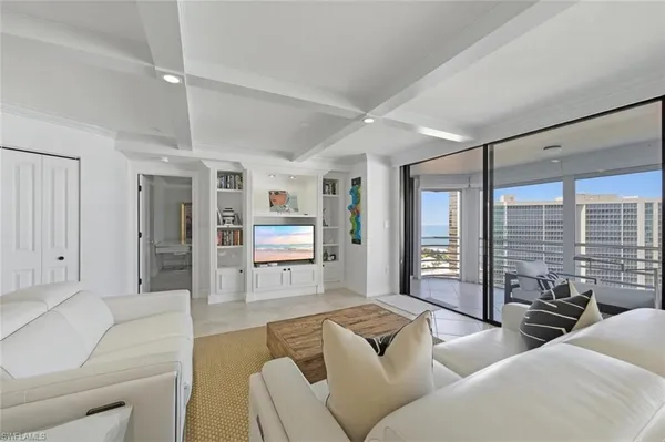 a living room with furniture and large windows