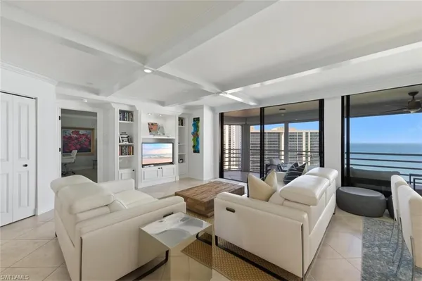 a living room with furniture and large windows