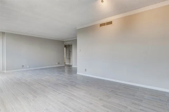 a kitchen with stainless steel appliances granite countertop a refrigerator a stove top oven a sink dishwasher and wooden floor