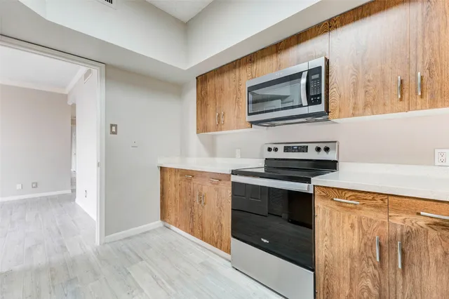 a kitchen with stainless steel appliances cabinets and a kitchen counter space