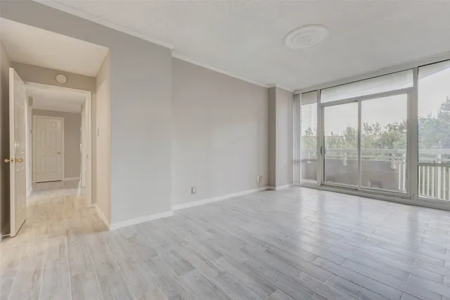 a view of an empty room and wooden floor