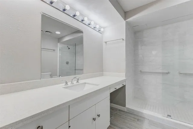 a bathroom with a shower and toilet