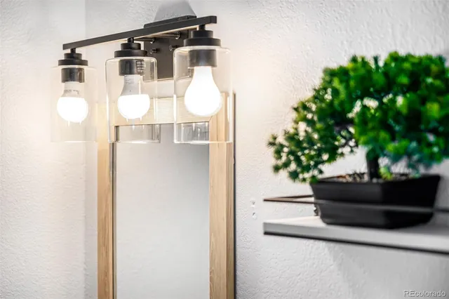 a bedroom with a bed and a lamp on table