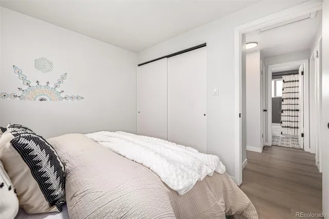 a bedroom with a bed and painting on the wall