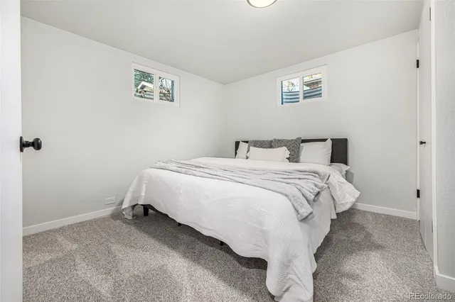 a bedroom with a bed and a mirror