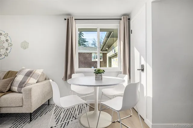 a dining room with furniture and window