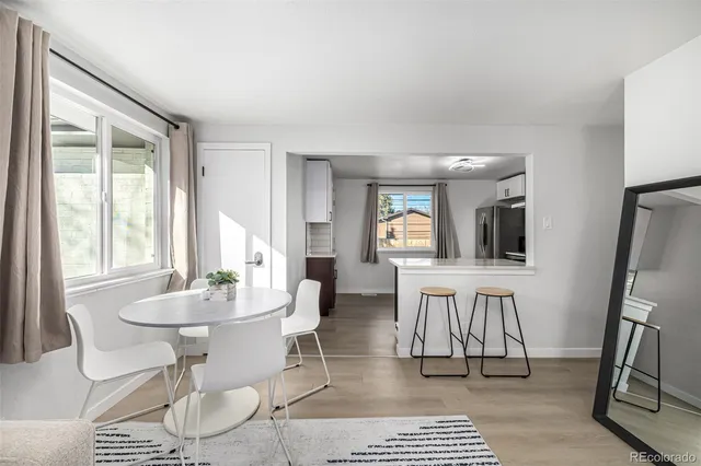 a view of a dining room with furniture and a potted plant