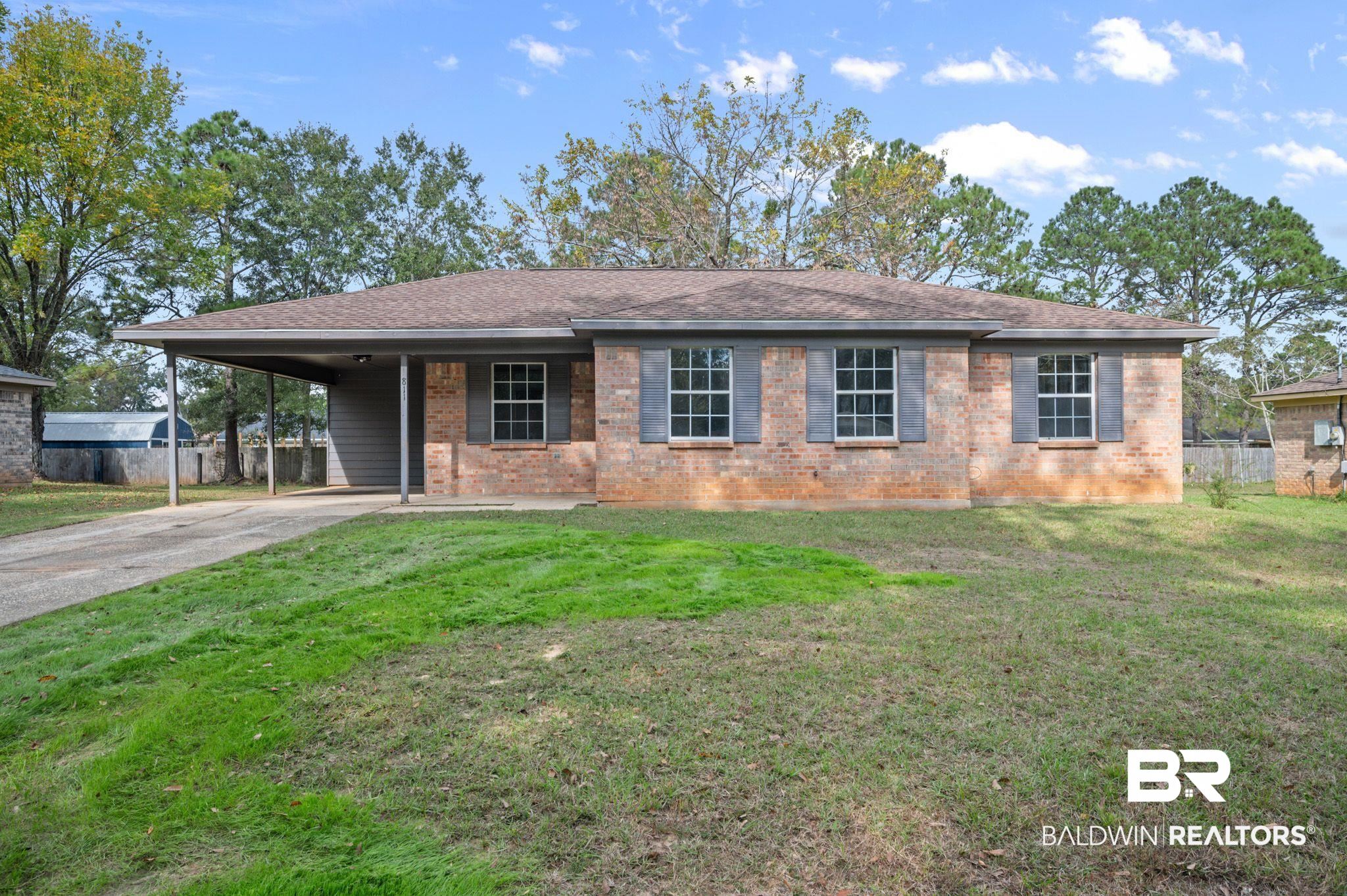 811 East Verbena Avenue Foley, AL 36535 - Photo 8 of 16 Single story home featuring a front yard and a carport
