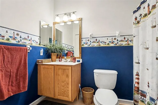 a bathroom with a toilet a sink and a mirror