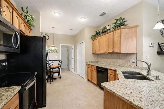 a kitchen with a sink a counter and cabinets